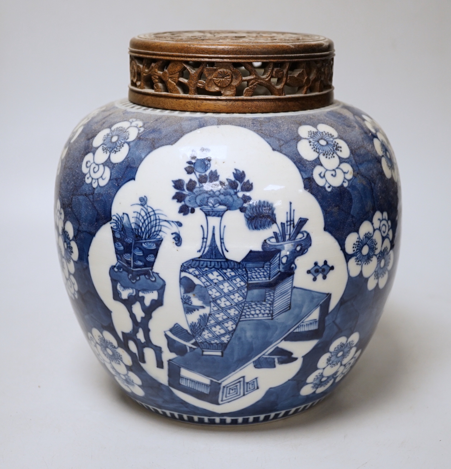 A 19th century Chinese blue and white prunus jar and carved wood cover, 24cm